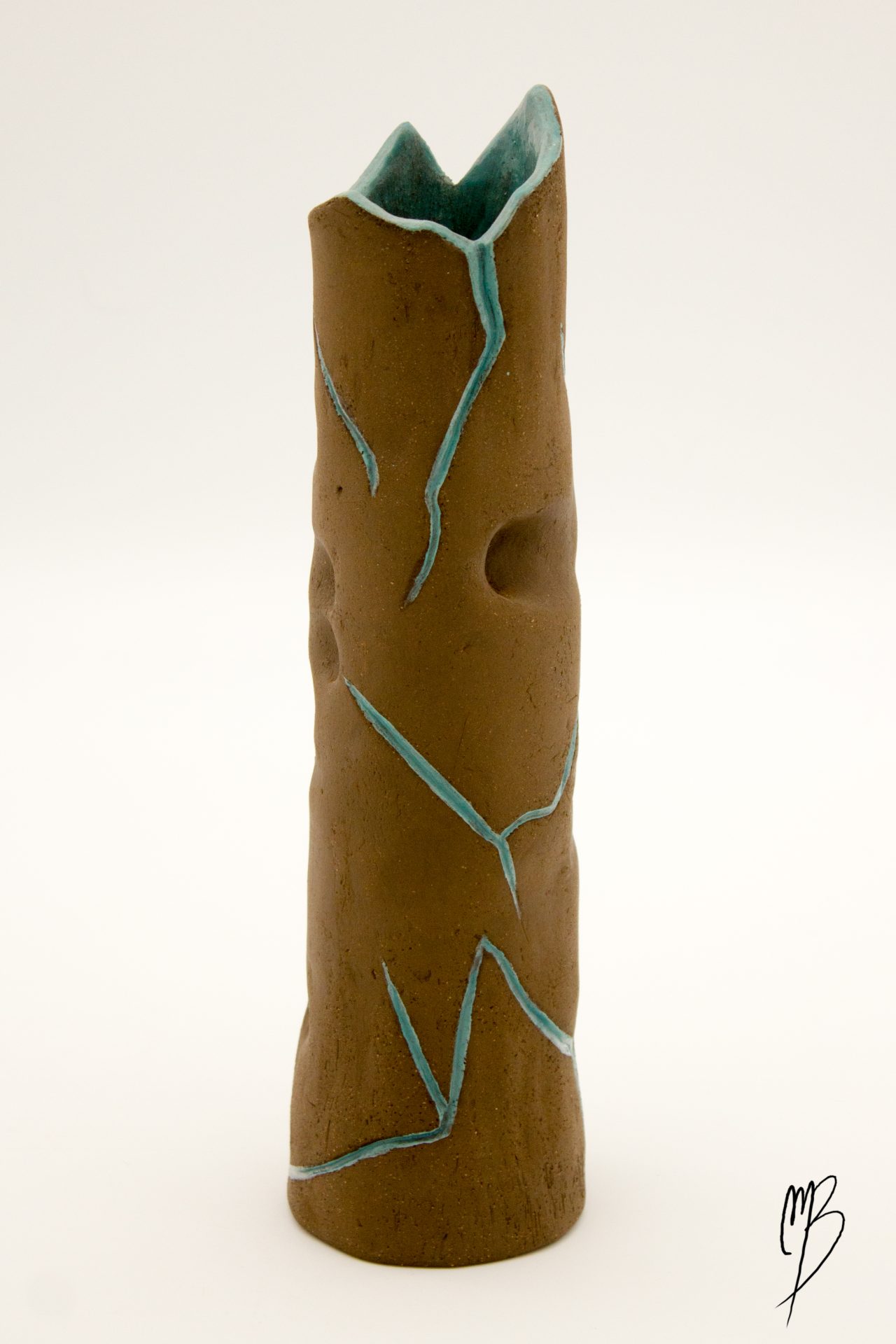 modelages sculptures d'un vase haut et fin orné d'un tronc d'arbre abstrait marron strié de bleu en terre émaillé