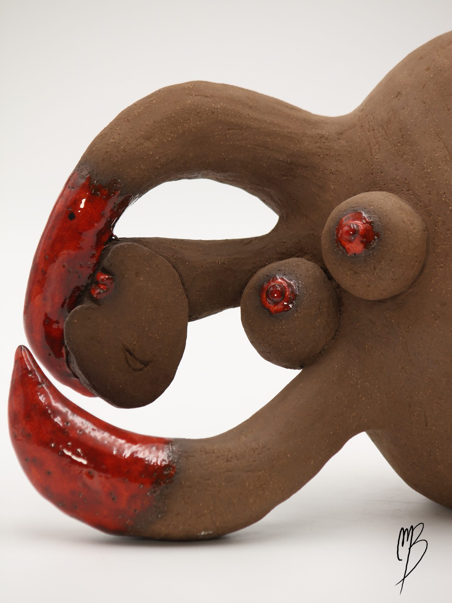 galipette en Terre chamottée cuite avec des éléments patinés de rouges émaillé.